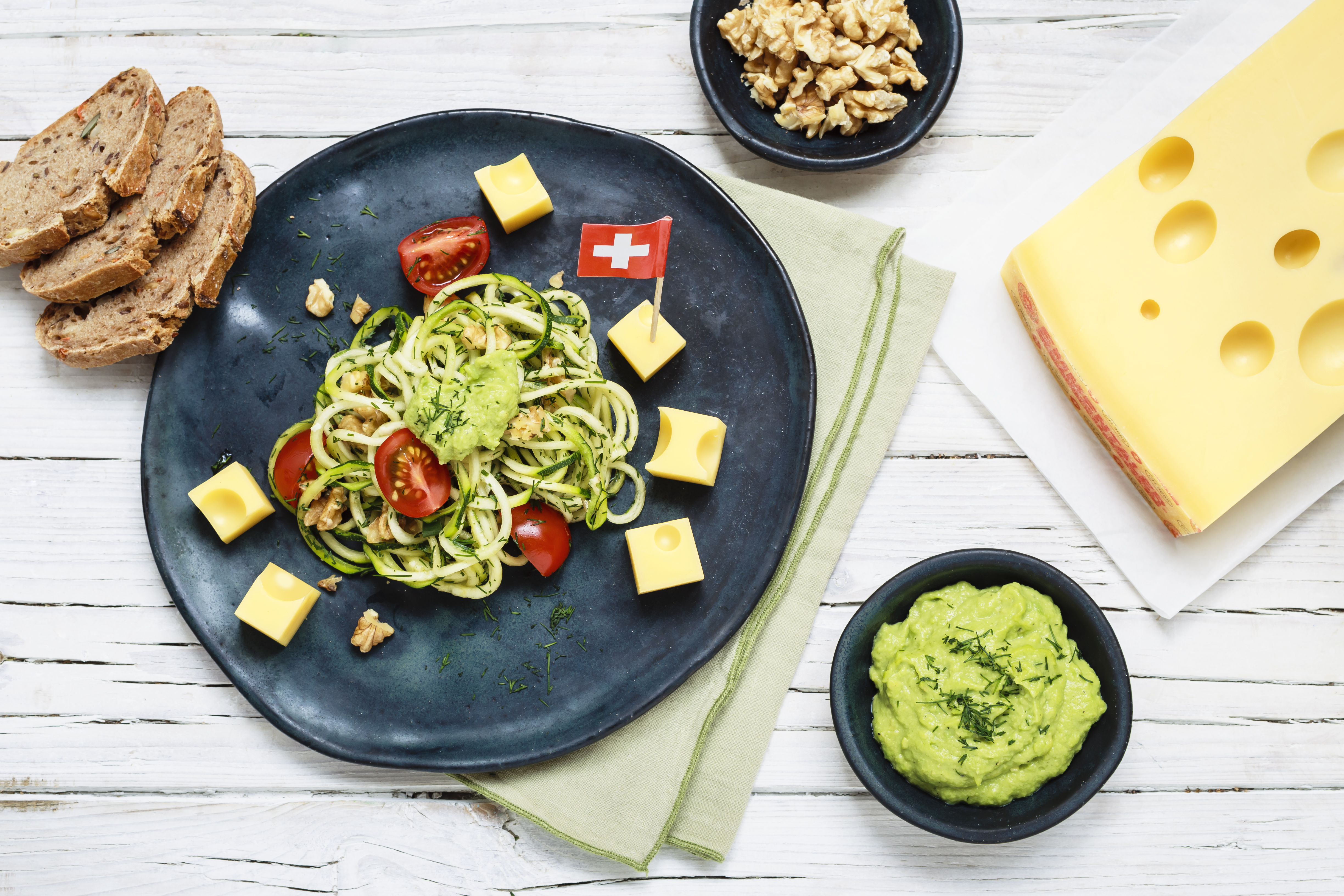 Zucchini noodles with avocado cream sauce and Swiss Emmental AOP